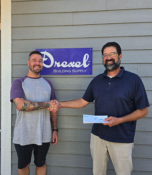 Waushara Food Pantry Executive Director receiving donation check from Drexel Building Supply