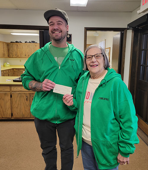 Waushara Food Pantry Executive Director receiving donation check